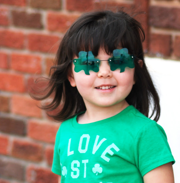 Little Girl wears shamrock glasses on St. Patrick's Day