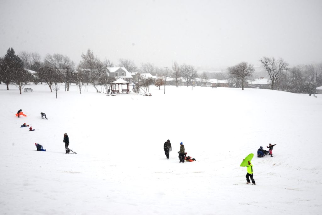 People Sledding on a snow day