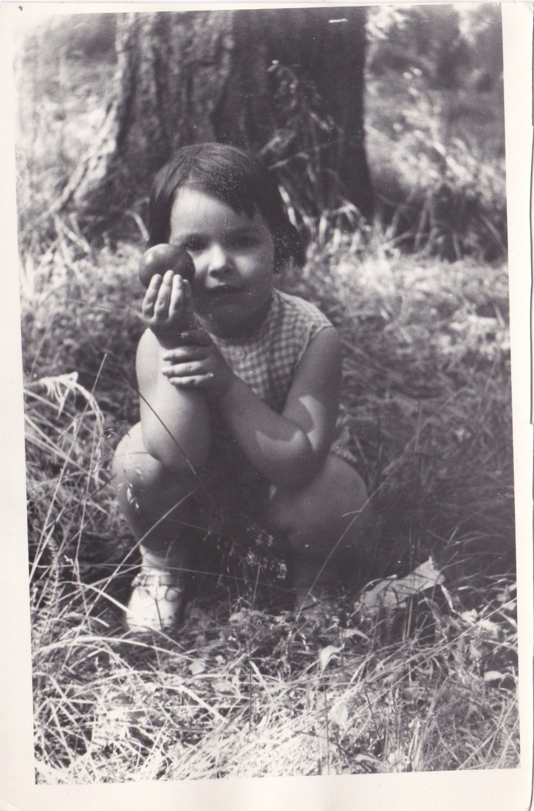 russian girl 1975 holds piece of fruit