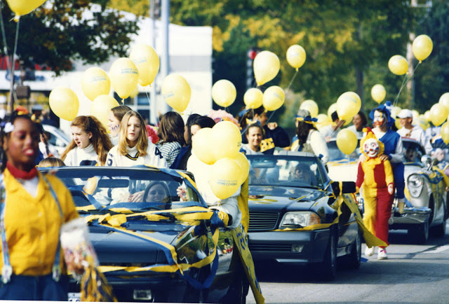 Football Homecoming Parade with cars and balloons. 