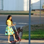 Girl in a Dress on a Scoote
